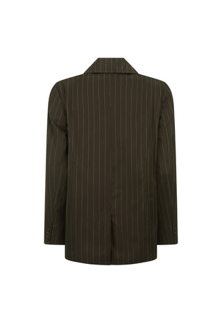 A woman modeling an oversized dark brown pinstripe blazer over a matching brown lace-up top and shorts