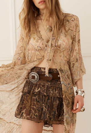  wearing a dark brown graphic long-sleeve shirt