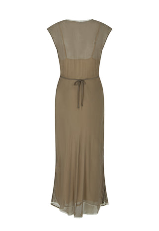A close-up lifestyle shot of a model wearing a brown semi-sheer draped dress with a deep V-neckline and layered silver necklaces.
